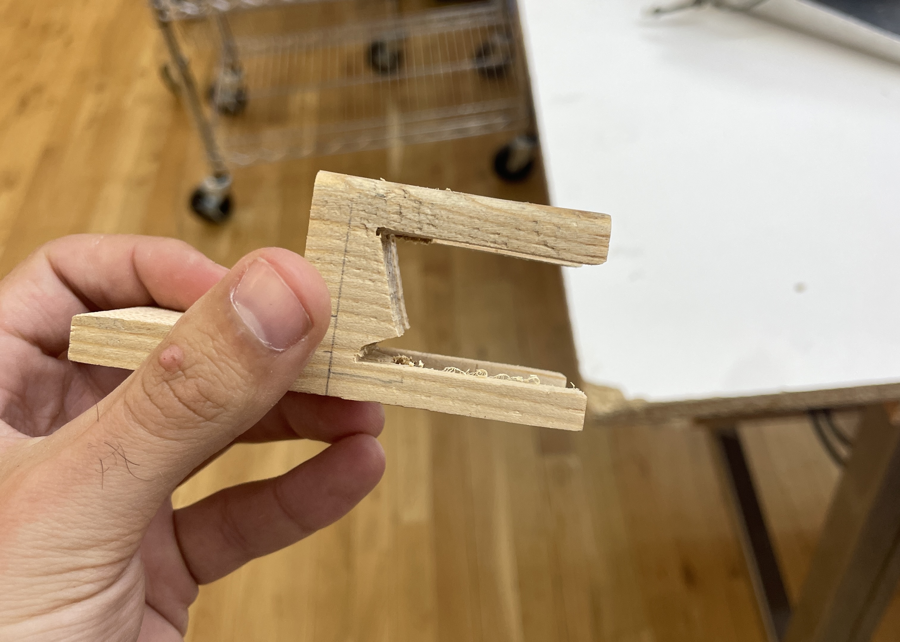 Removign most of the excess wood from the legs of a wooden chair