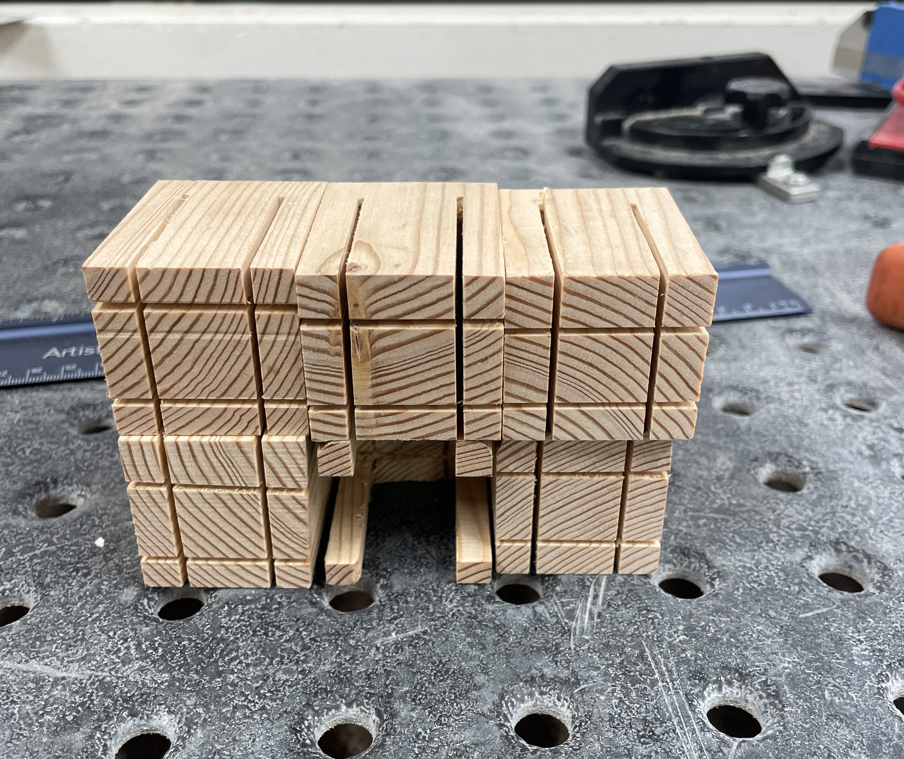 Six small wooden chairs stacked on one another